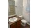 A standard bathroom, with a vanity, toilet, and a shower over the tub and window with blinds at 1247 Shoreham Dr, Atlanta, GA 30349