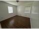 Bright, minimalist bedroom with two windows and modern wood-look flooring at 1247 Shoreham Dr, Atlanta, GA 30349