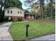 Charming two-story home with a brick facade and well-maintained lawn at 1247 Shoreham Dr, Atlanta, GA 30349