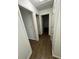 Bright hallway with wood-look flooring that leads to various rooms at 1247 Shoreham Dr, Atlanta, GA 30349