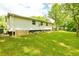 View of the home's spacious backyard with lush greenery and ample space at 1303 Cochise Cir, Austell, GA 30168
