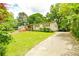 Charming single-Gathering home with a spacious front yard and ample parking space on driveway at 1303 Cochise Cir, Austell, GA 30168