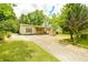 Inviting single-story home with charming front porch and mature trees around the property at 1303 Cochise Cir, Austell, GA 30168