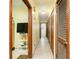 Long hallway with multiple doors and neutral colored tile flooring at 1303 Cochise Cir, Austell, GA 30168