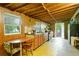 Rustic kitchen with wooden cabinets, exposed ceiling beams, and a dining area at 1303 Cochise Cir, Austell, GA 30168