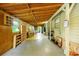 Long unfinished room with exposed wood ceiling, multiple windows, and storage shelving at 1303 Cochise Cir, Austell, GA 30168