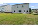 Expansive backyard with lush green lawn, patio seating, and a view of the home's rear exterior at 221 Begonia Way, Mcdonough, GA 30253