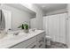 Bright bathroom featuring a double sink vanity, large mirror, and shower with white curtain at 221 Begonia Way, Mcdonough, GA 30253