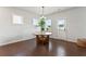 Modern dining area features a unique table with hardwood floors and natural light at 221 Begonia Way, Mcdonough, GA 30253
