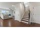 Inviting foyer with hardwood floors and a staircase leading to the upper level of the house at 221 Begonia Way, Mcdonough, GA 30253