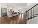 Bright, open-concept living space featuring hardwood floors and a modern kitchen with an island and bar seating at 221 Begonia Way, Mcdonough, GA 30253