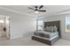 Bright main bedroom with carpeting, tray ceiling, and a door to the bath at 221 Begonia Way, Mcdonough, GA 30253