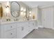 Bright bathroom with double sink vanity, white cabinets, and stylish lighting at 3143 Denton Ne Pl, Roswell, GA 30075