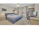 Comfortable bedroom with a well-lit desk area, complemented by a large window with neighborhood views at 3143 Denton Ne Pl, Roswell, GA 30075