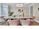 This dining room features a modern chandelier, neutral colors, and comfortable seating at 3143 Denton Ne Pl, Roswell, GA 30075