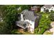 An aerial view of the backyard showing mature trees, lush landscaping, and a porch at 3143 Denton Ne Pl, Roswell, GA 30075