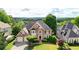 Stunning two-story brick home with a well-manicured front lawn and mature trees at 3143 Denton Ne Pl, Roswell, GA 30075