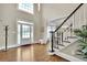 Bright foyer with hardwood floors, a staircase with white railings, and a view of the dining room at 3143 Denton Ne Pl, Roswell, GA 30075