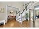 Inviting foyer featuring hardwood floors, a staircase, and an open view to the dining area at 3143 Denton Ne Pl, Roswell, GA 30075