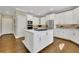 This kitchen features stainless appliances, a large island, and white cabinets at 3143 Denton Ne Pl, Roswell, GA 30075