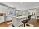 Bright eat-in kitchen with white cabinets, stainless appliances, and an island cooktop at 3143 Denton Ne Pl, Roswell, GA 30075