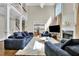 Spacious living room with high ceilings, large windows, a fireplace, and comfortable blue seating at 3143 Denton Ne Pl, Roswell, GA 30075