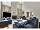Bright and airy living room showcasing a fireplace, tall windows, and stylish furnishings at 3143 Denton Ne Pl, Roswell, GA 30075