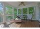 Relaxing screened porch offers wooden floors, ceiling fan, and plenty of natural light at 3143 Denton Ne Pl, Roswell, GA 30075