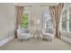 Bright sitting room with matching chairs, accent table, and large windows at 3143 Denton Ne Pl, Roswell, GA 30075