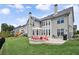Expansive backyard with a patio, fire pit area, and lush landscaping at 320 Harvest View Ter, Woodstock, GA 30188