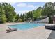 Community pool with lounge chairs and large tanning deck at 320 Harvest View Ter, Woodstock, GA 30188