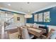 Dining area with hardwood floors, a modern chandelier, and a glimpse of the staircase at 320 Harvest View Ter, Woodstock, GA 30188