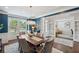Formal dining room with hardwood floors, blue accent wall, chandelier, and seating for six at 320 Harvest View Ter, Woodstock, GA 30188