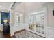 Elegant foyer with tall ceilings, hardwood floors, framed by white pillars, and a lovely entryway rug at 320 Harvest View Ter, Woodstock, GA 30188