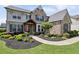 Attractive home with stone and gray wood facade, manicured landscaping, and a welcoming walkway at 320 Harvest View Ter, Woodstock, GA 30188