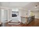 Open hallway featuring hardwood floors, and a staircase with iron spindles at 320 Harvest View Ter, Woodstock, GA 30188