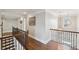 Elegant hallway with hardwood floors, decorative lighting, and detailed trim work at 320 Harvest View Ter, Woodstock, GA 30188