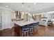 Open concept kitchen with granite counters, island seating, and easy access to the living area at 320 Harvest View Ter, Woodstock, GA 30188