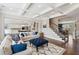 Bright, open living room featuring coffered ceilings, hardwood floors, and an open flow to the kitchen at 320 Harvest View Ter, Woodstock, GA 30188