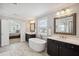 Bright main bathroom with double vanity, freestanding tub, and private toilet room at 320 Harvest View Ter, Woodstock, GA 30188