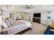 Bright main bedroom with tray ceilings, neutral decor, and a large dresser with tv at 320 Harvest View Ter, Woodstock, GA 30188