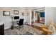 Home office featuring a glass desk, a blue velvet chair, and an area rug over hardwood floors at 320 Harvest View Ter, Woodstock, GA 30188