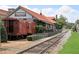 Charming restaurant exterior with railway car detail, tracks, and inviting outdoor seating at 320 Harvest View Ter, Woodstock, GA 30188
