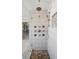 Luxurious shower with multiple jets, rain shower head, and stone-tiled floor at 320 Harvest View Ter, Woodstock, GA 30188