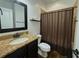 Bathroom featuring granite countertop, shower with curtain, and wood floors at 4769 Moon Hollow Ct, Buford, GA 30519