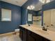Bathroom featuring double sinks, a large mirror, and great natural light at 4769 Moon Hollow Ct, Buford, GA 30519