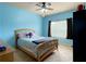 Bedroom painted light blue and equipped with ceiling fan and large window at 4769 Moon Hollow Ct, Buford, GA 30519