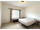 Bright bedroom with carpet floor, ceiling light and a window with blinds at 4769 Moon Hollow Ct, Buford, GA 30519