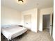 Bright bedroom with carpet floor, ceiling light and a closet with double doors at 4769 Moon Hollow Ct, Buford, GA 30519