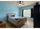 Bedroom painted light blue and equipped with ceiling fan and large window at 4769 Moon Hollow Ct, Buford, GA 30519